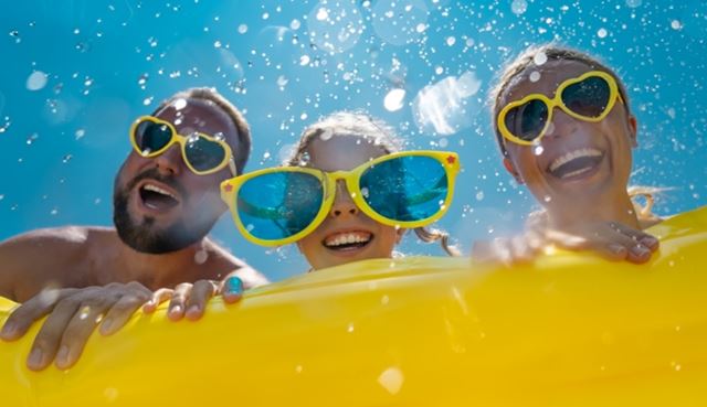 Family wearing sunglasses at a pool